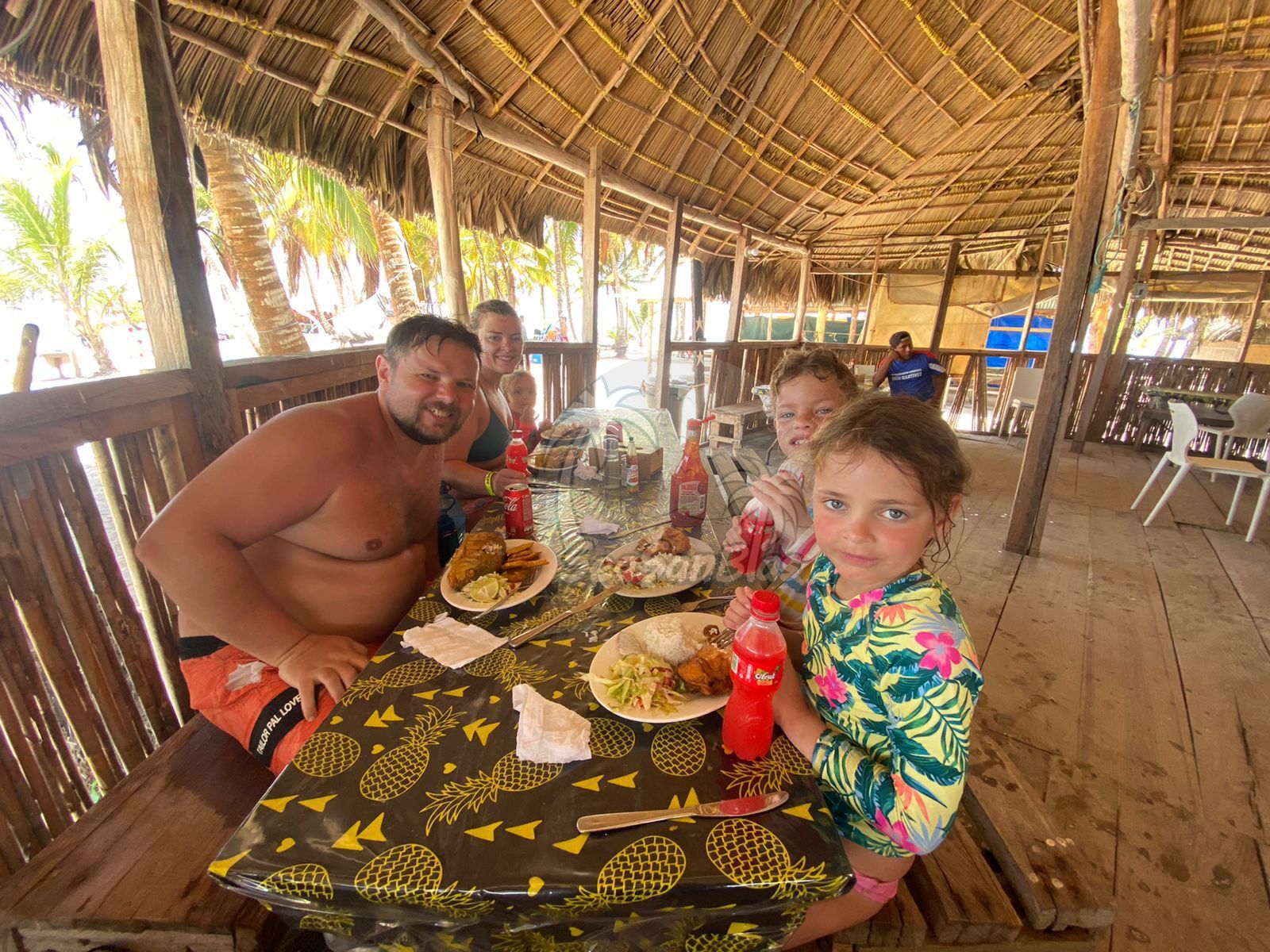 A group of people are sitting at a table eating food.