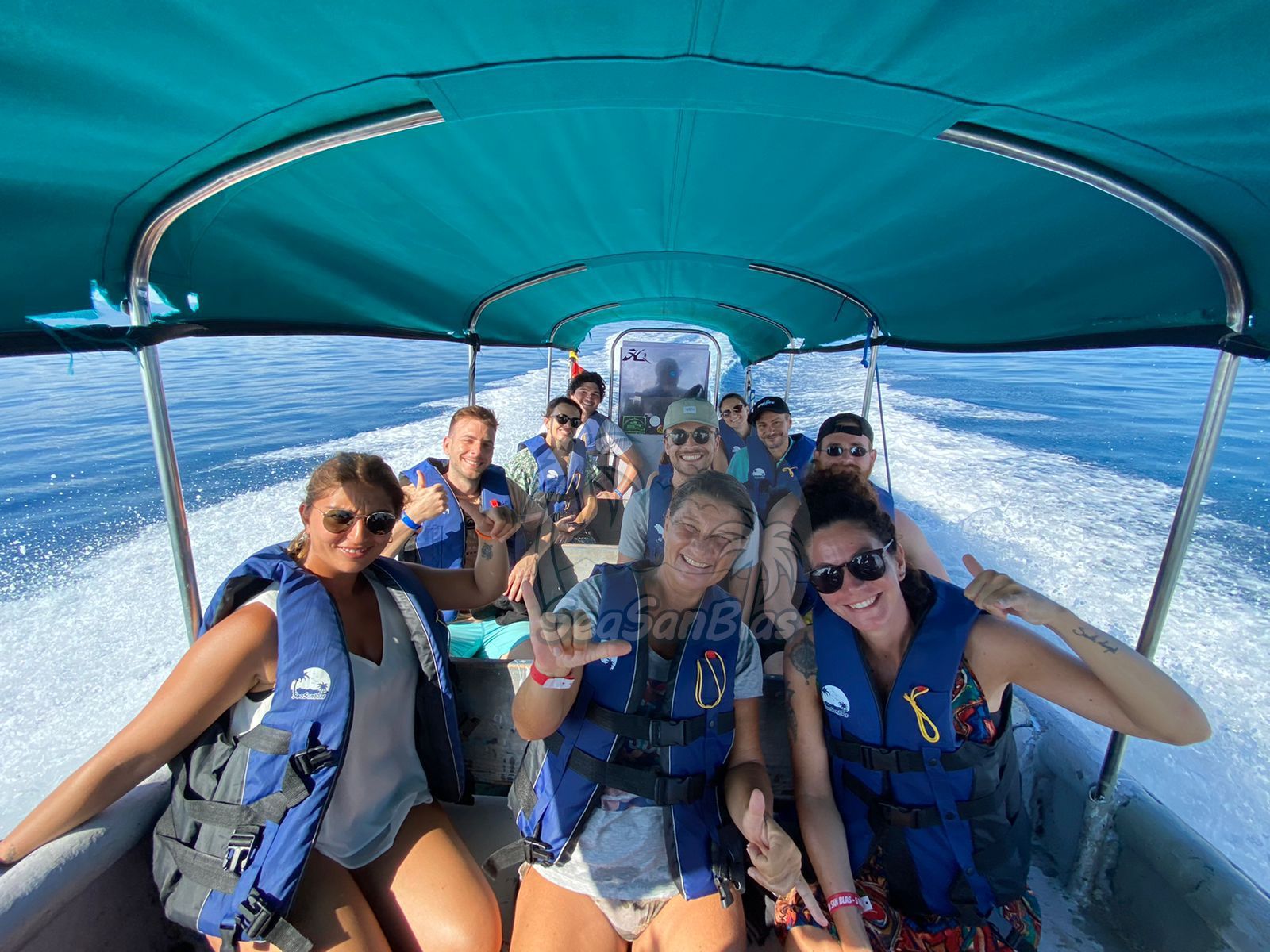 A group of people are riding on a boat in the ocean.