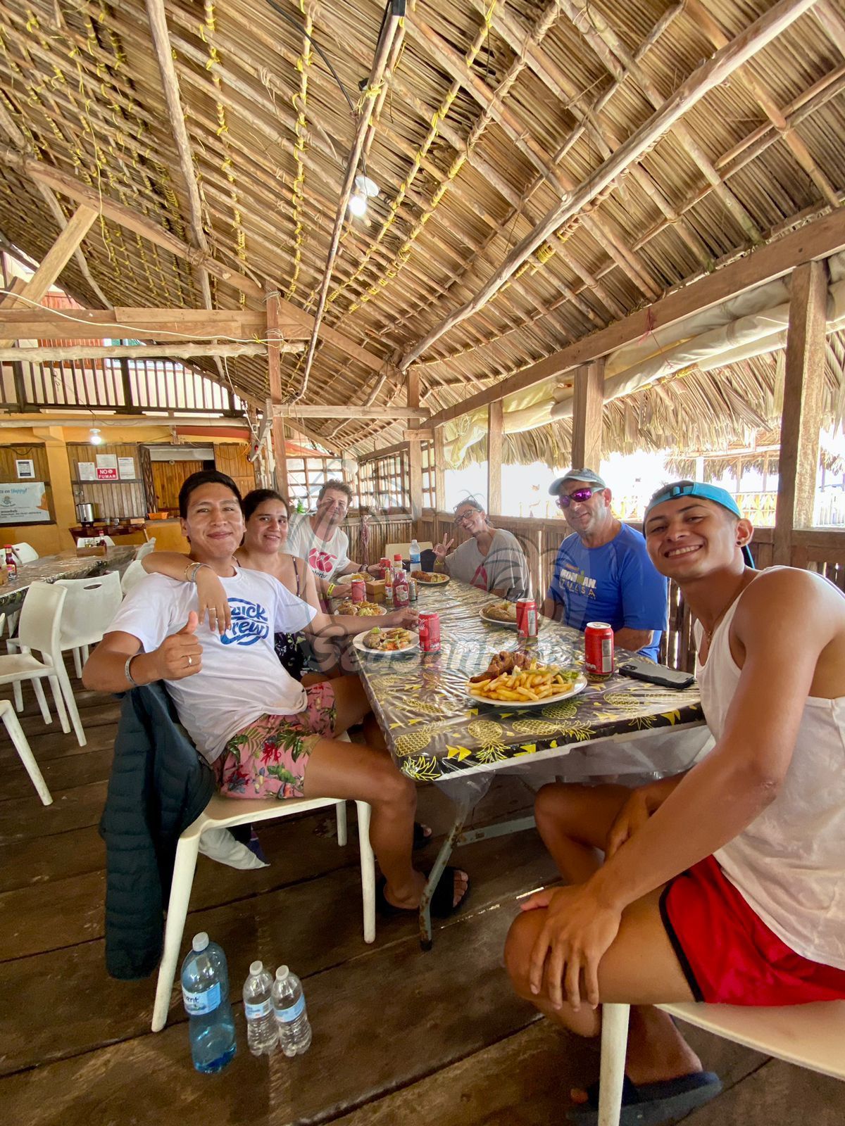 A group of people are sitting at a table in a restaurant. San Blas Islands Guna Yala San Blas Tours