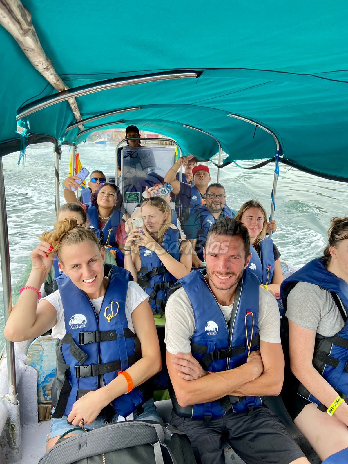 A group of people are sitting on a boat wearing life jackets. San Blas Islands Guna Yala San Blas Tours