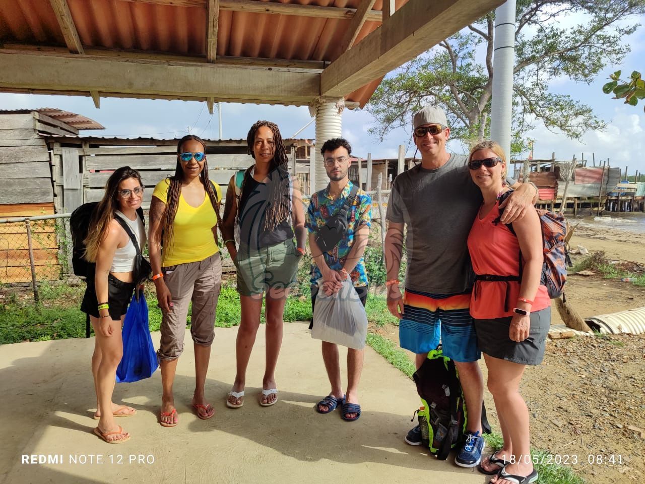 A group of people are posing for a picture in front of a building.