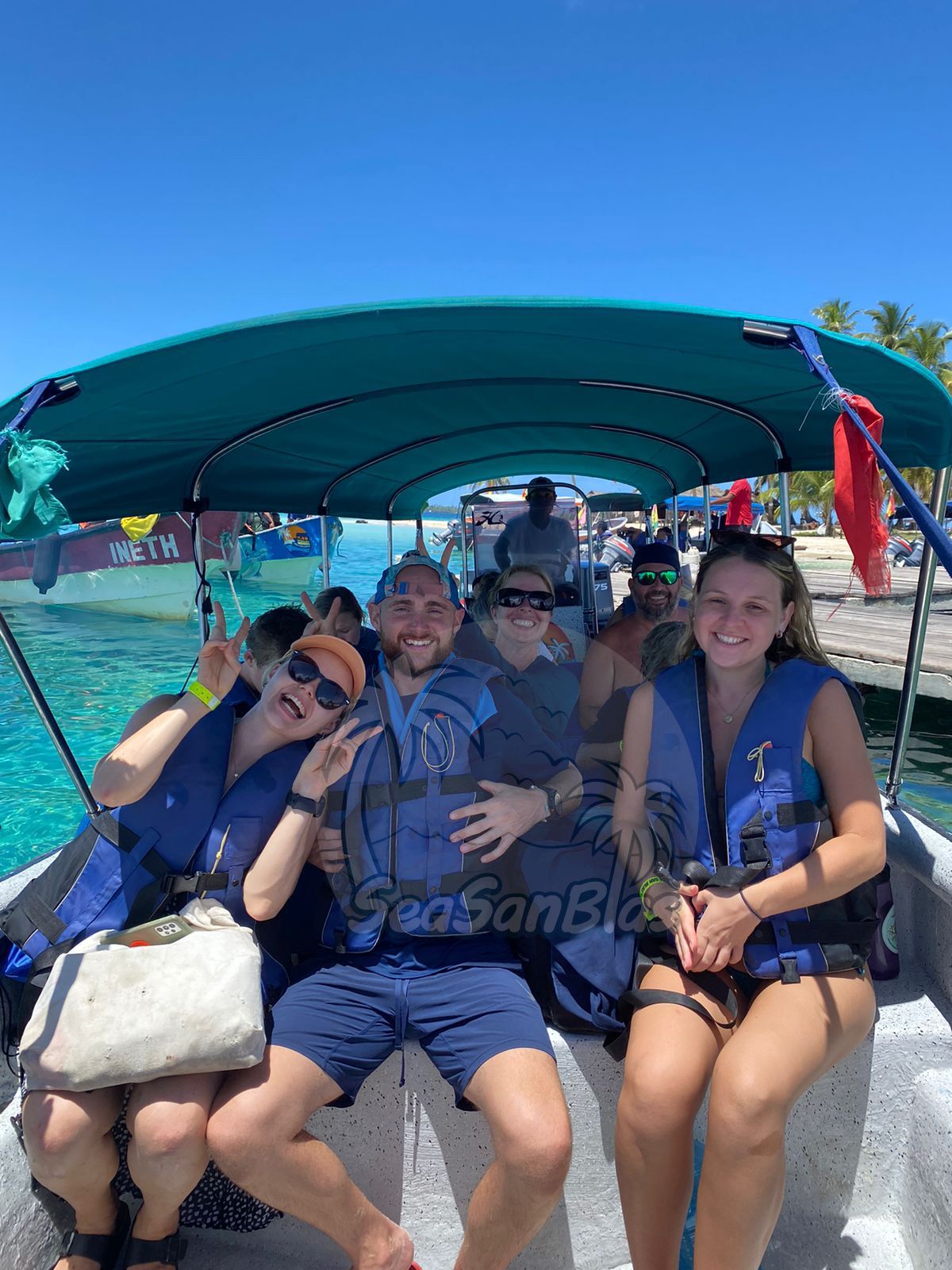 a group of people on a boat with the word seasanblue on the bottom