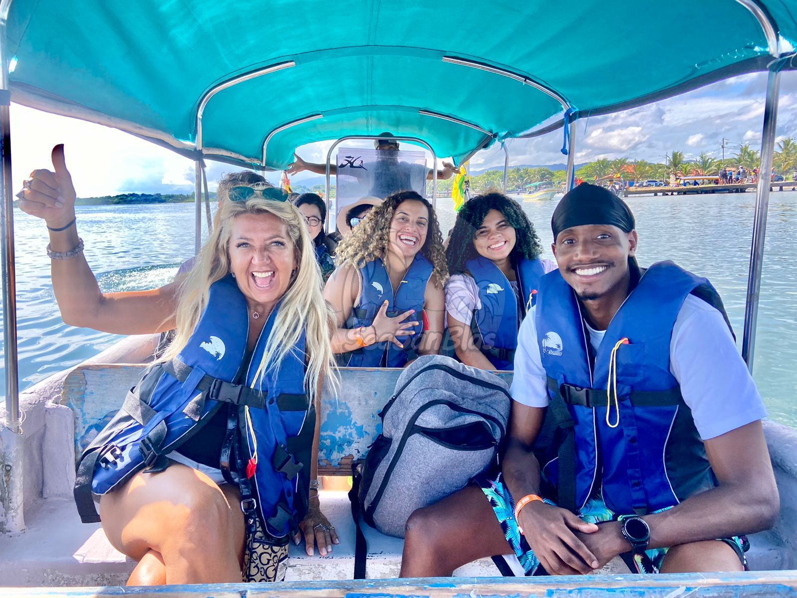 A group of people are sitting on a boat in the water. San Blas Islands Guna Yala San Blas Tours