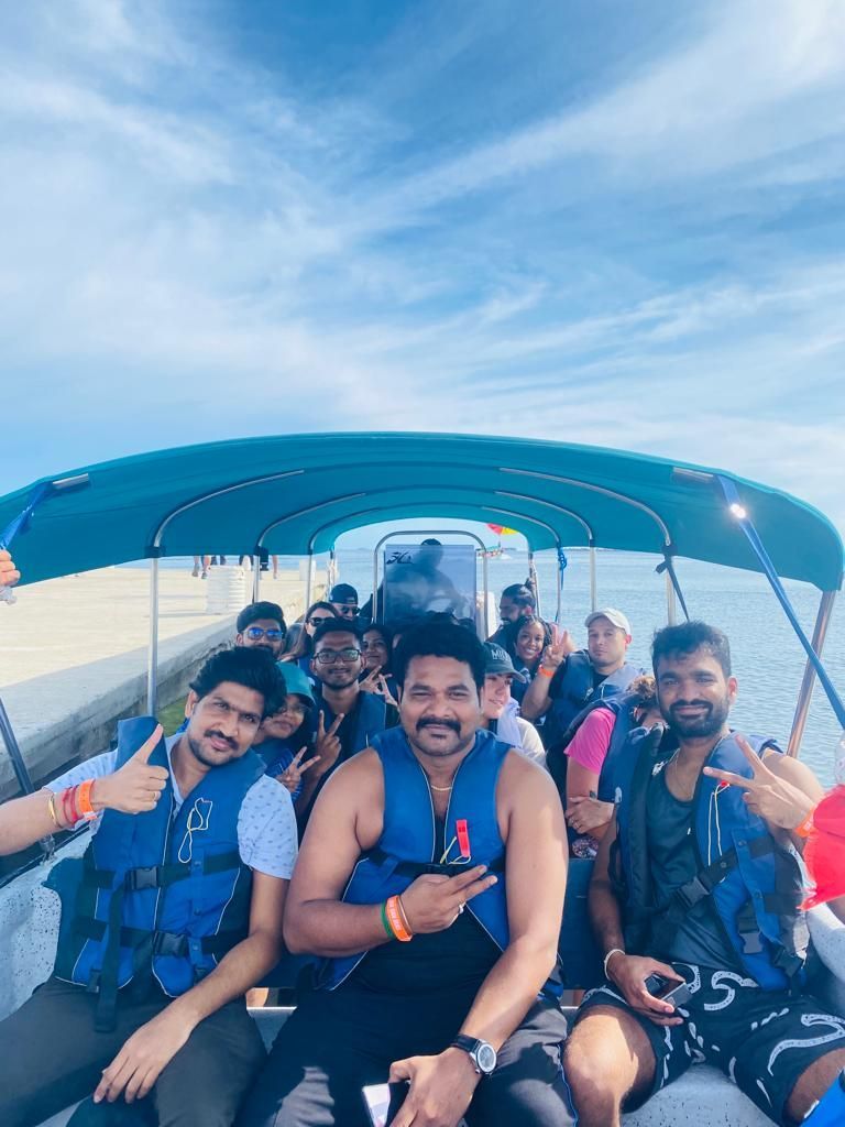 A group of people are sitting on a boat in the water.