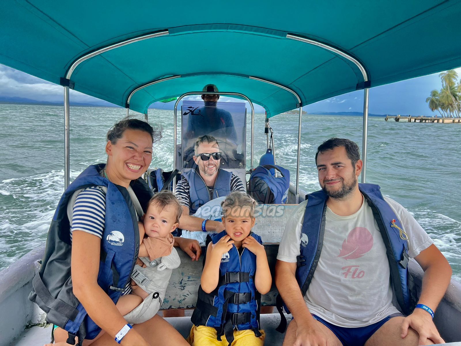 A family is sitting on a boat in the water. San Blas Islands Guna Yala San Blas Tours