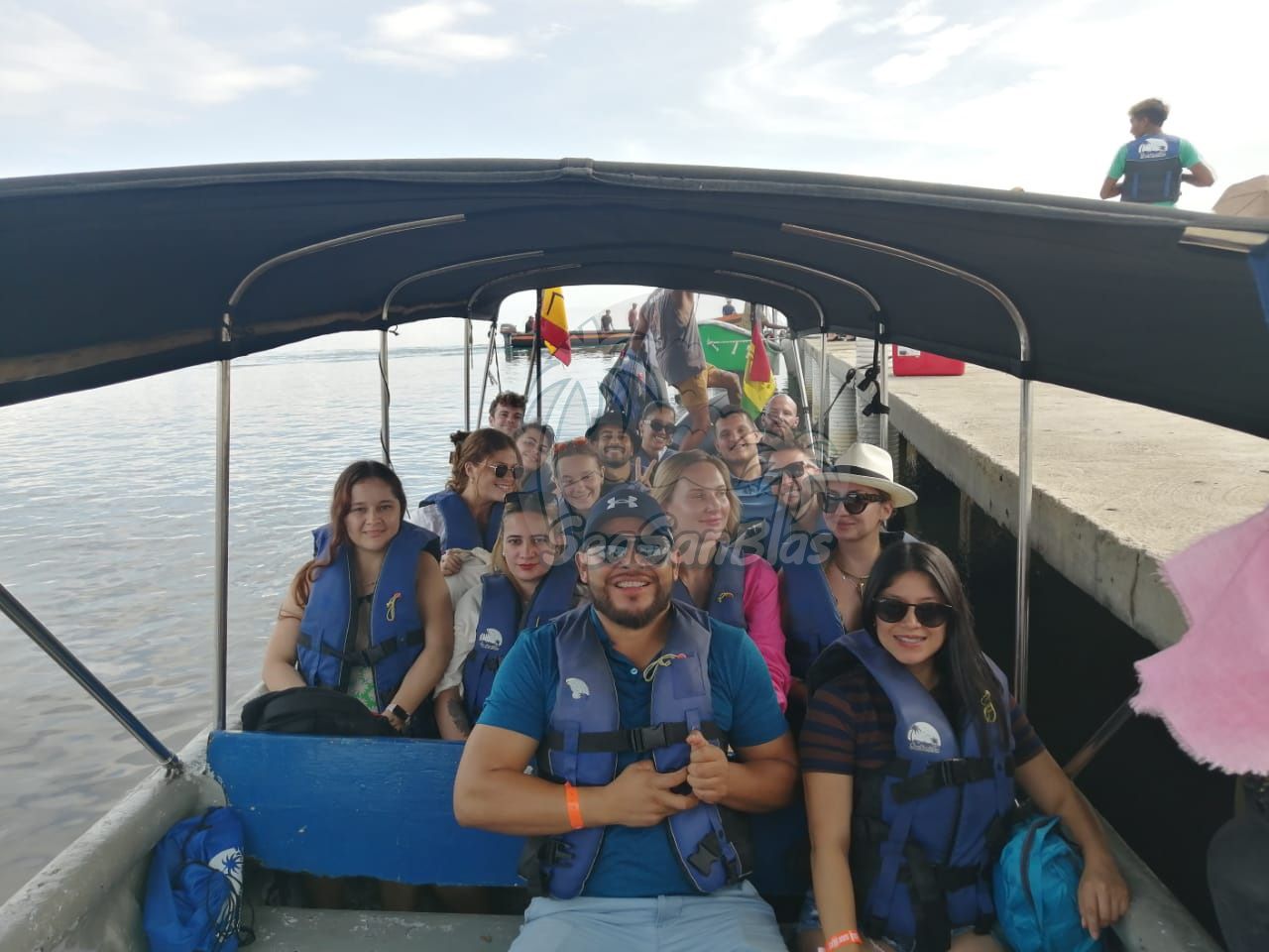 A group of people are sitting on a boat in the water. San Blas Islands Guna Yala San Blas Tours