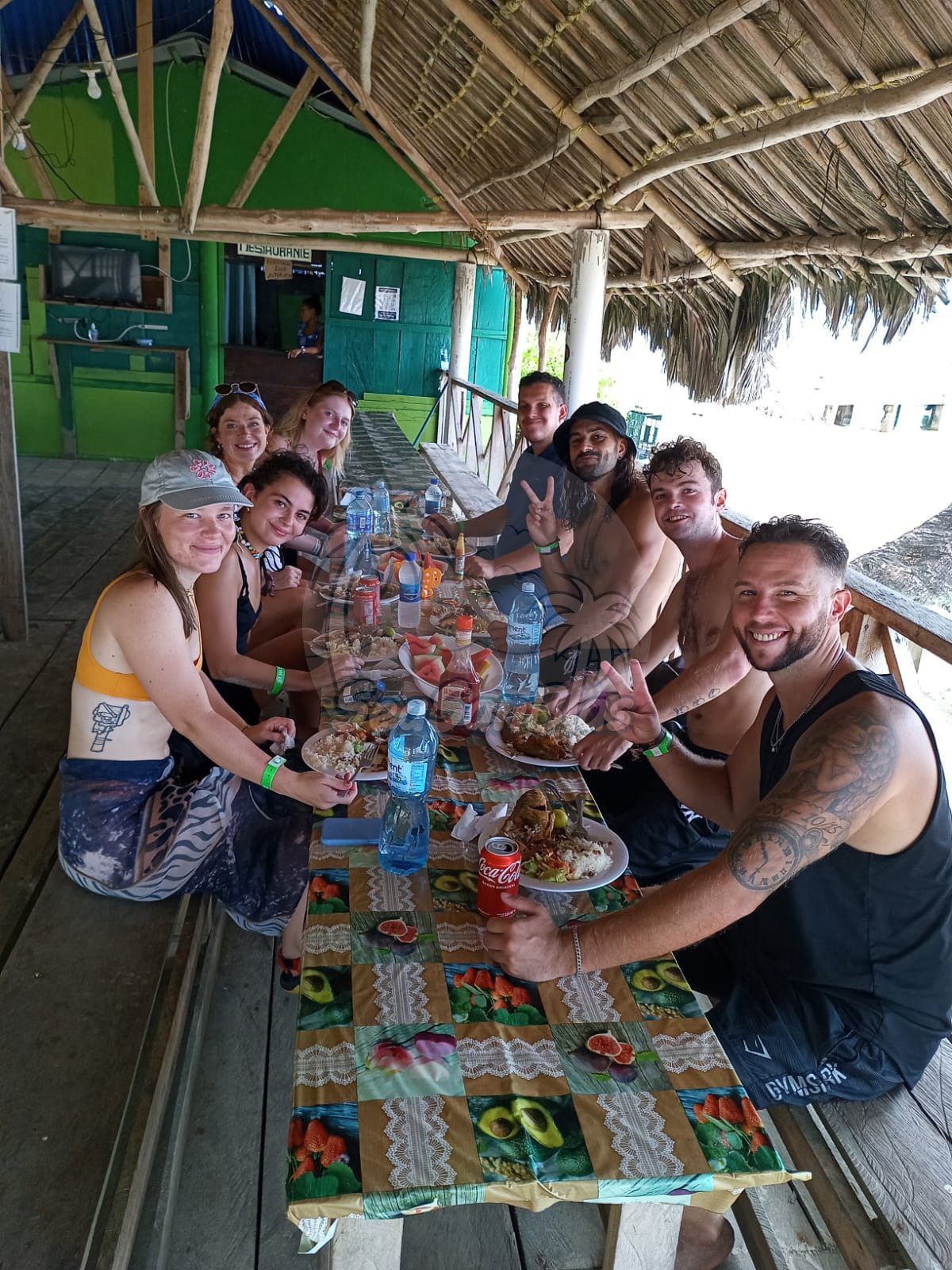 A group of people are sitting around a table eating food.  San Blas Islands Guna Yala San Blas Tours