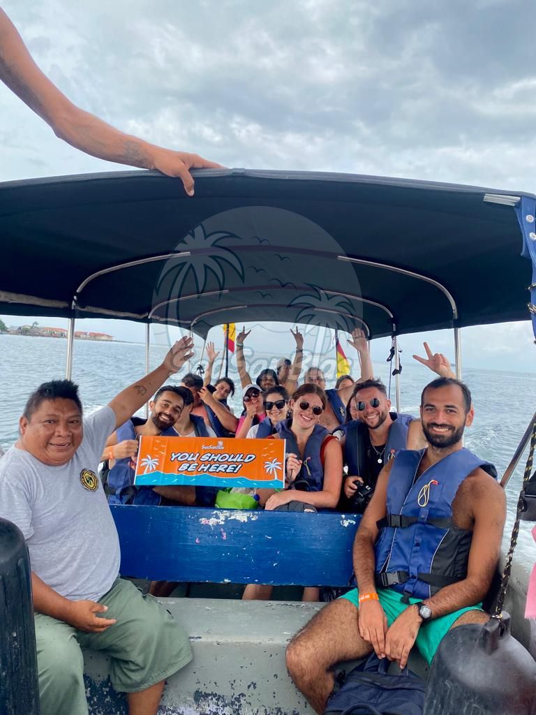 A group of people are sitting on a boat in the ocean.