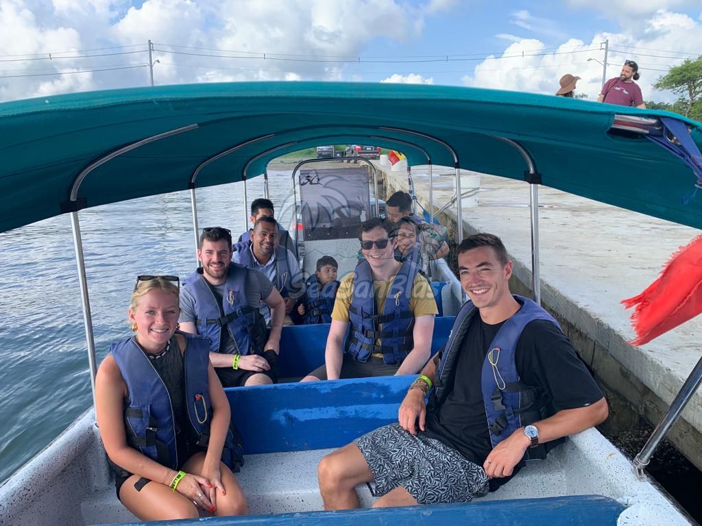 A group of people are sitting on a boat in the water.