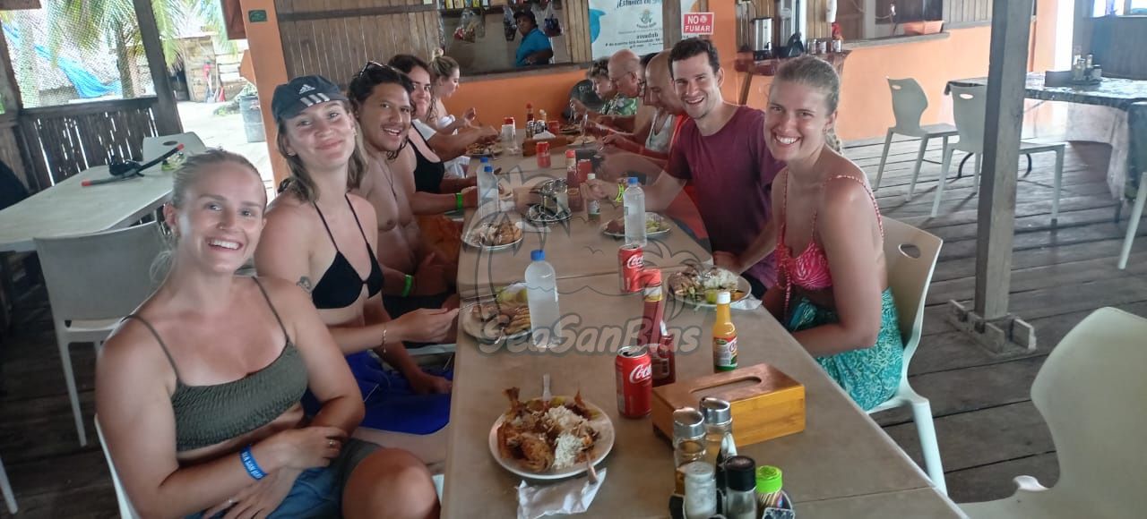 a group of people sitting at a table with coca cola cans on it