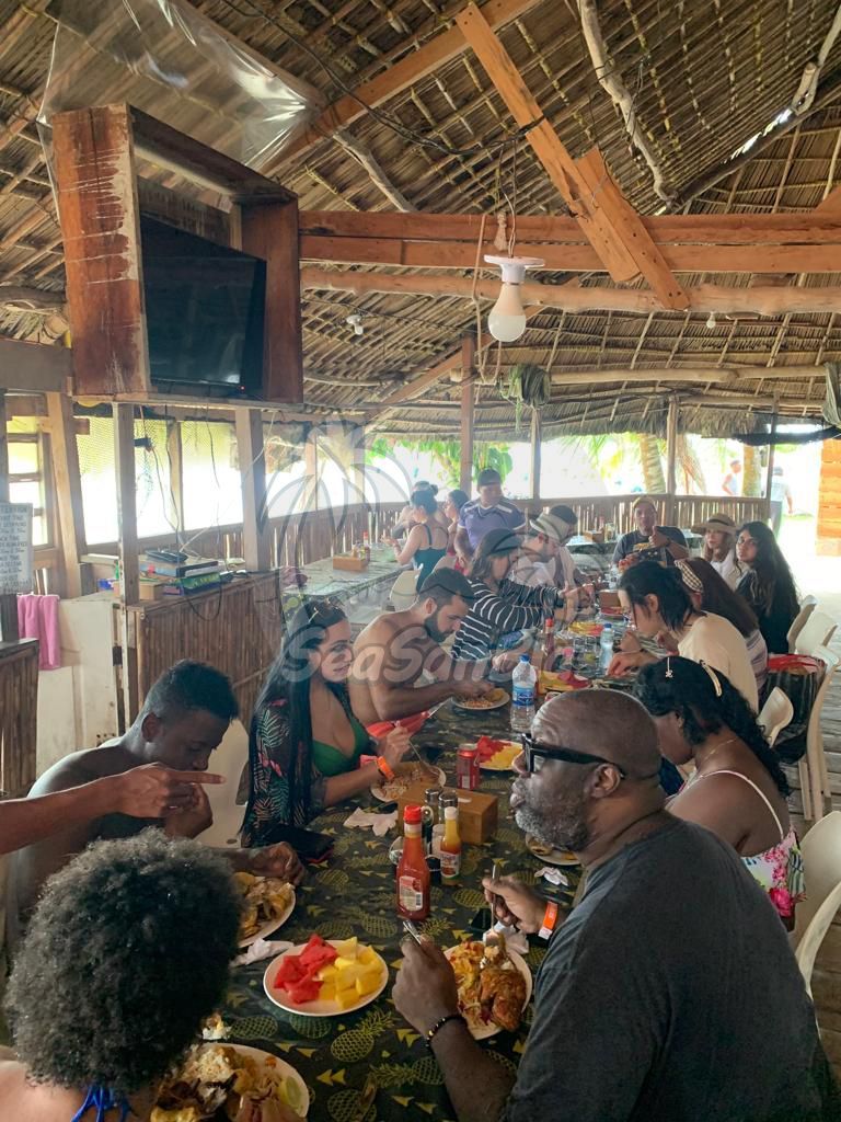 A group of people are sitting at a table eating food.