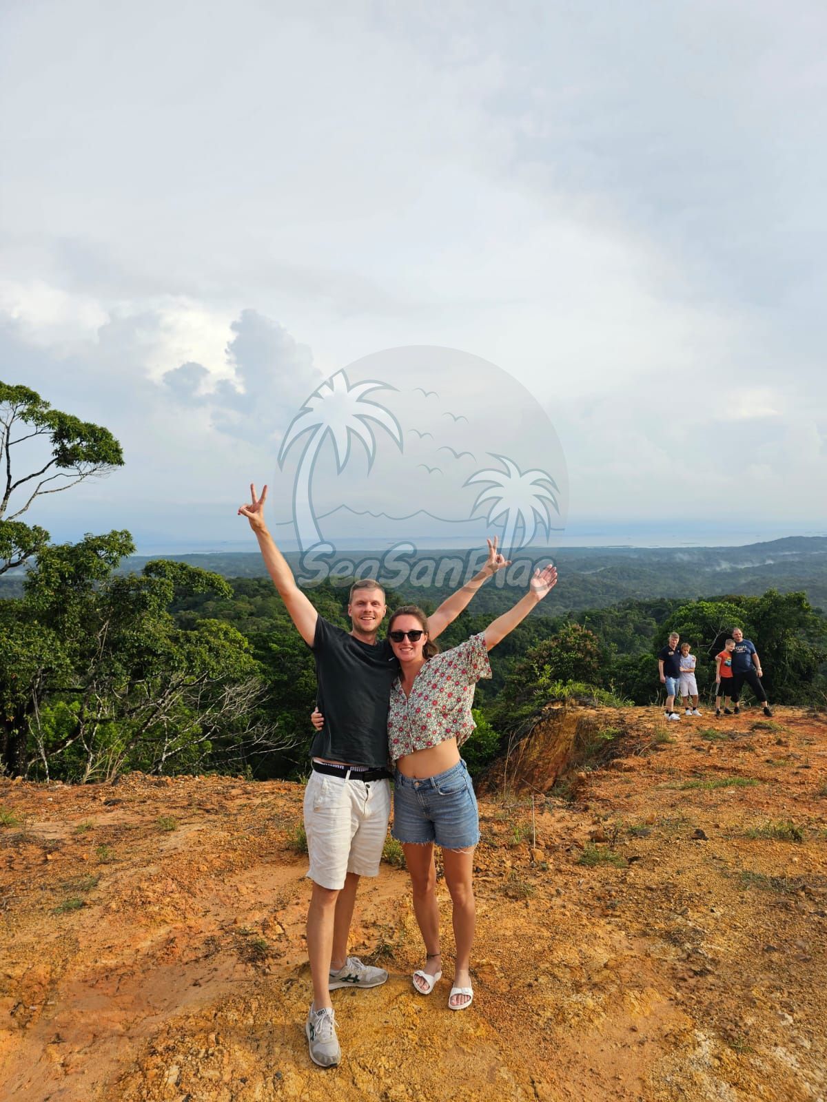 A man and a woman are standing on top of a dirt hill. San Blas Islands Guna Yala San Blas Tours