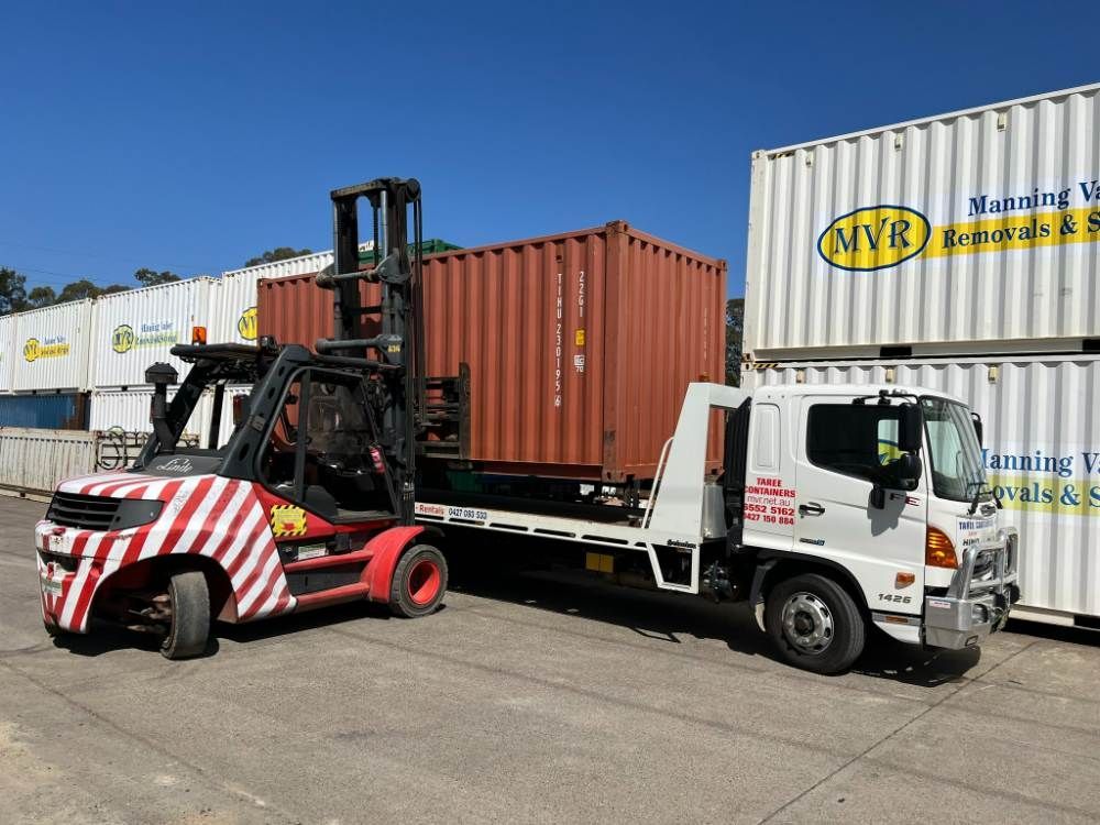A Forklift Is Loading A Container Onto A Truck — Taree Containers in Taree, NSW