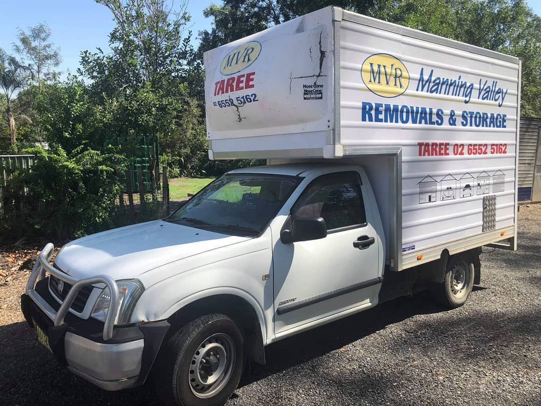 A White Truck With A Box On Top Of It Is Parked In A Driveway — Taree Containers in Taree, NSW