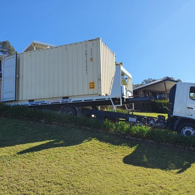 A White Truck Is Towing A Large Shipping Container — Taree Containers in Taree, NSW