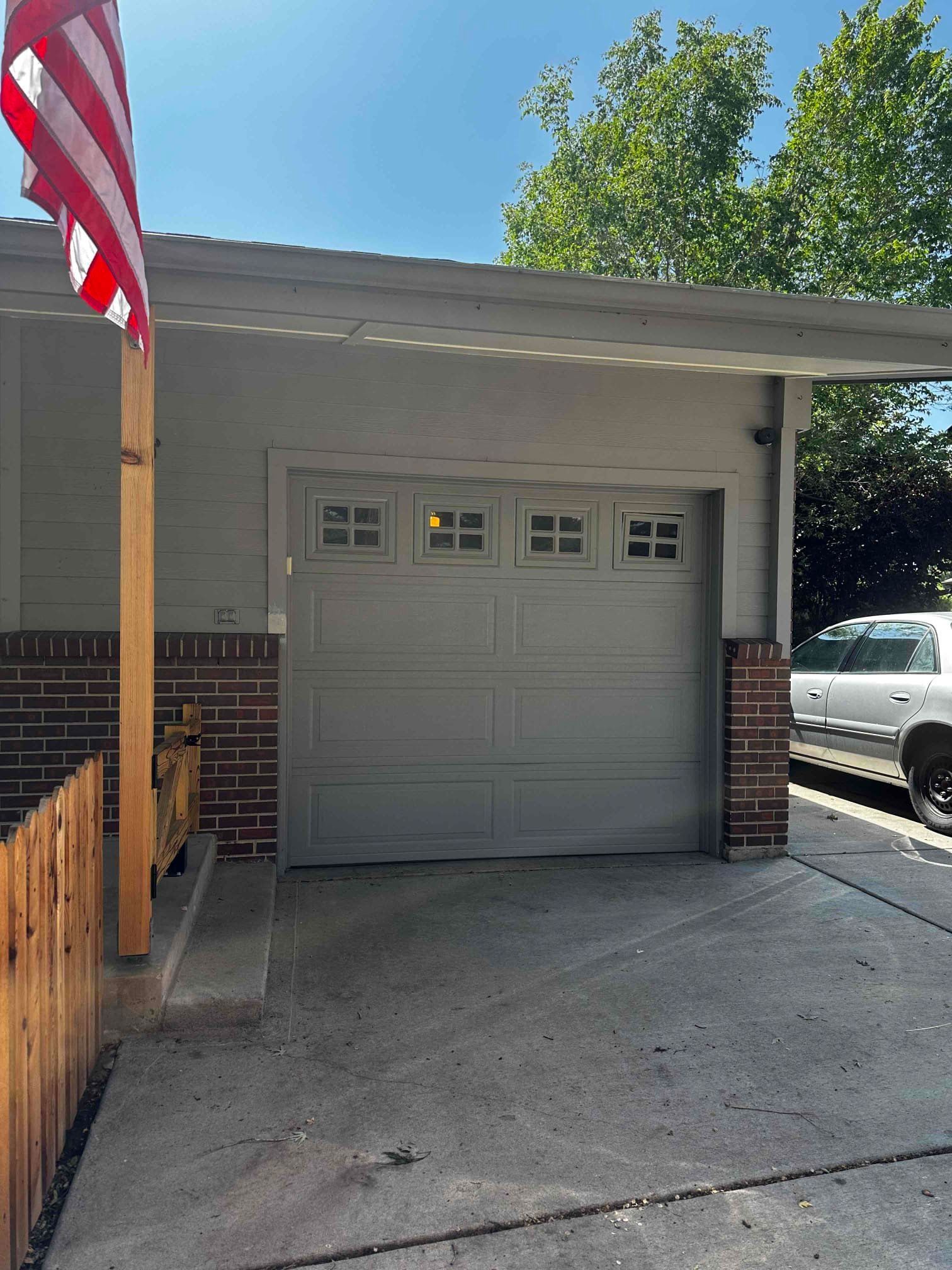 A one car garage door in white.