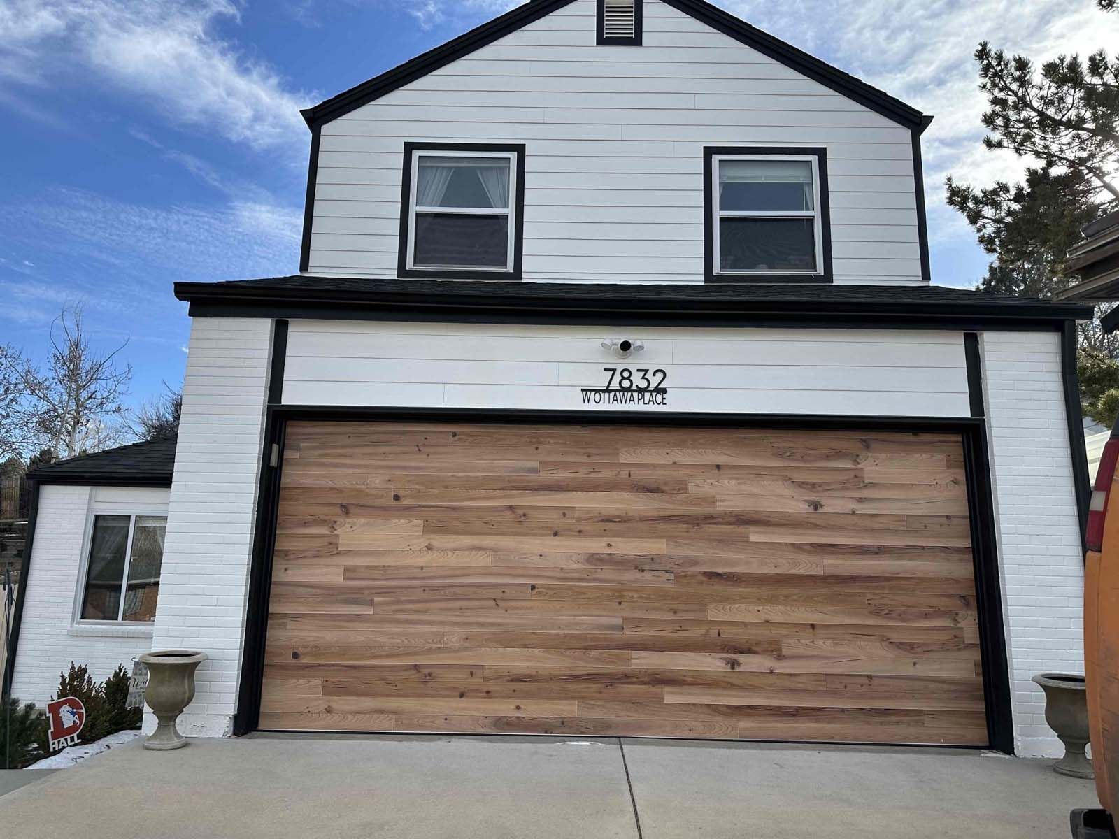 A white house with a wooden garage door