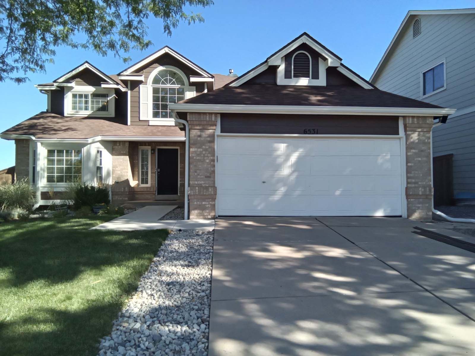 The front of a house with a white garage door