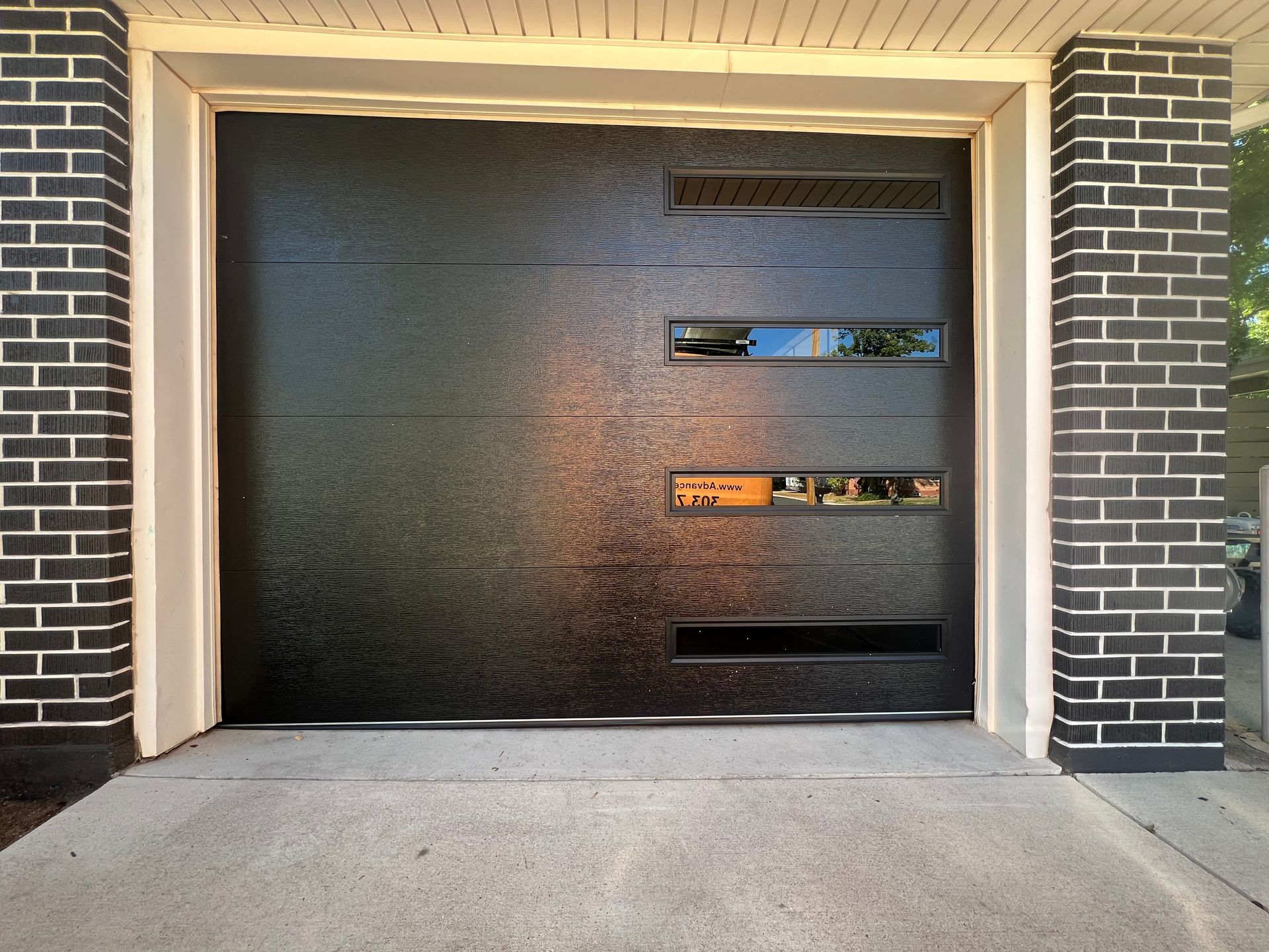 Single garage door, modern flush panel with mosaic windows installed in Denver, CO