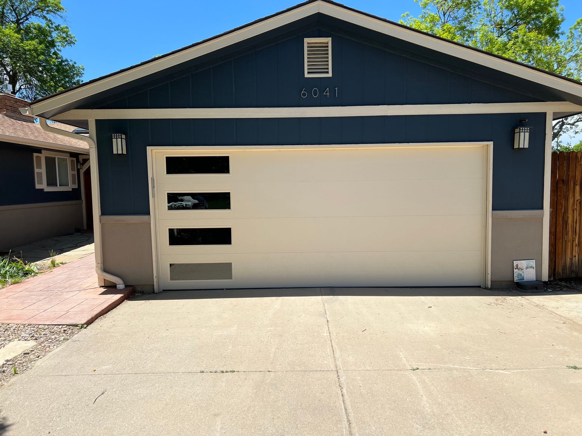 A blue house with a white garage door
