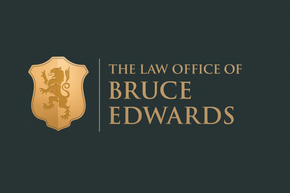 The logo for edwards law is a shield with a lion on it.