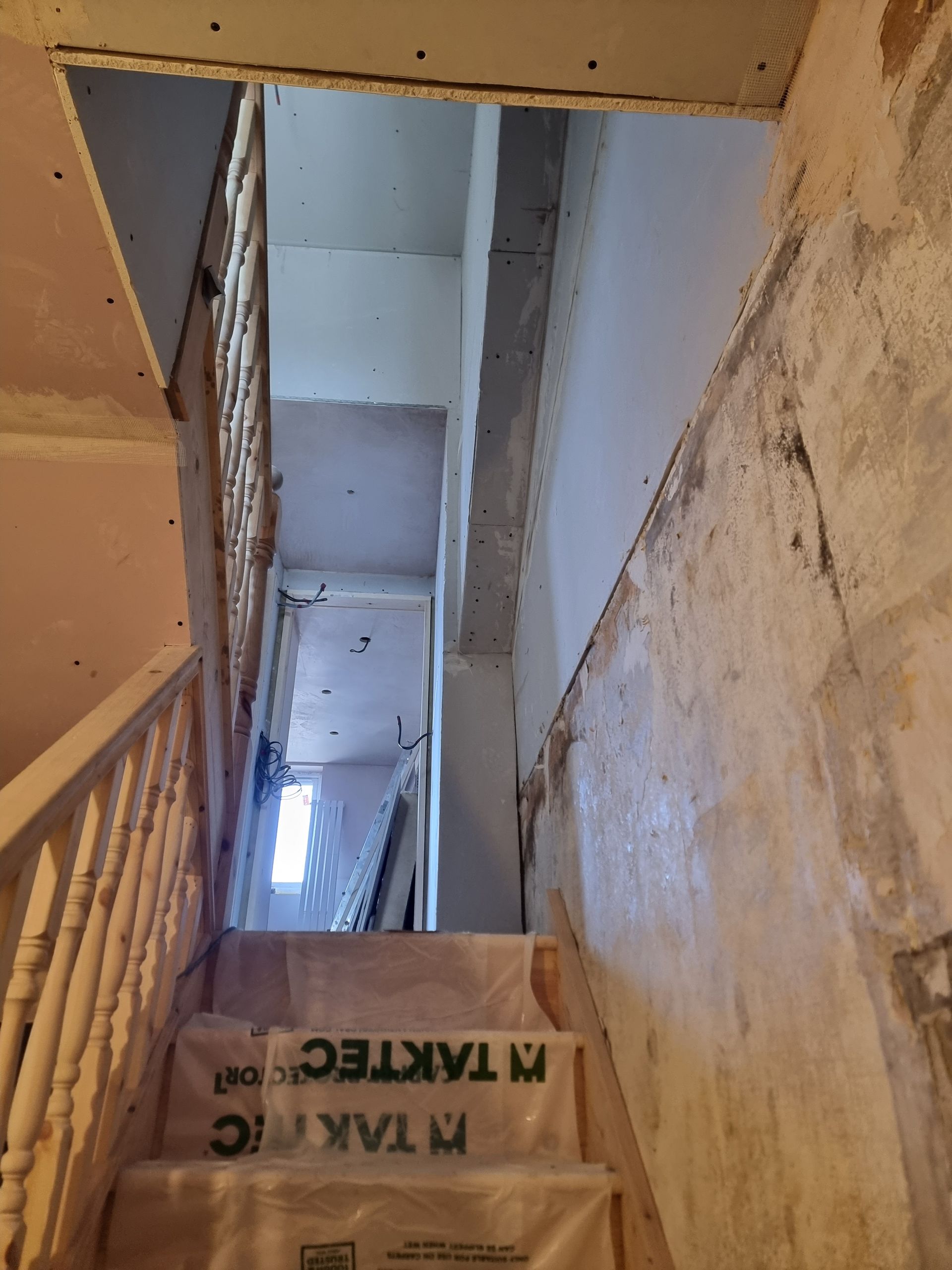 A staircase with a sign that says taktec on it