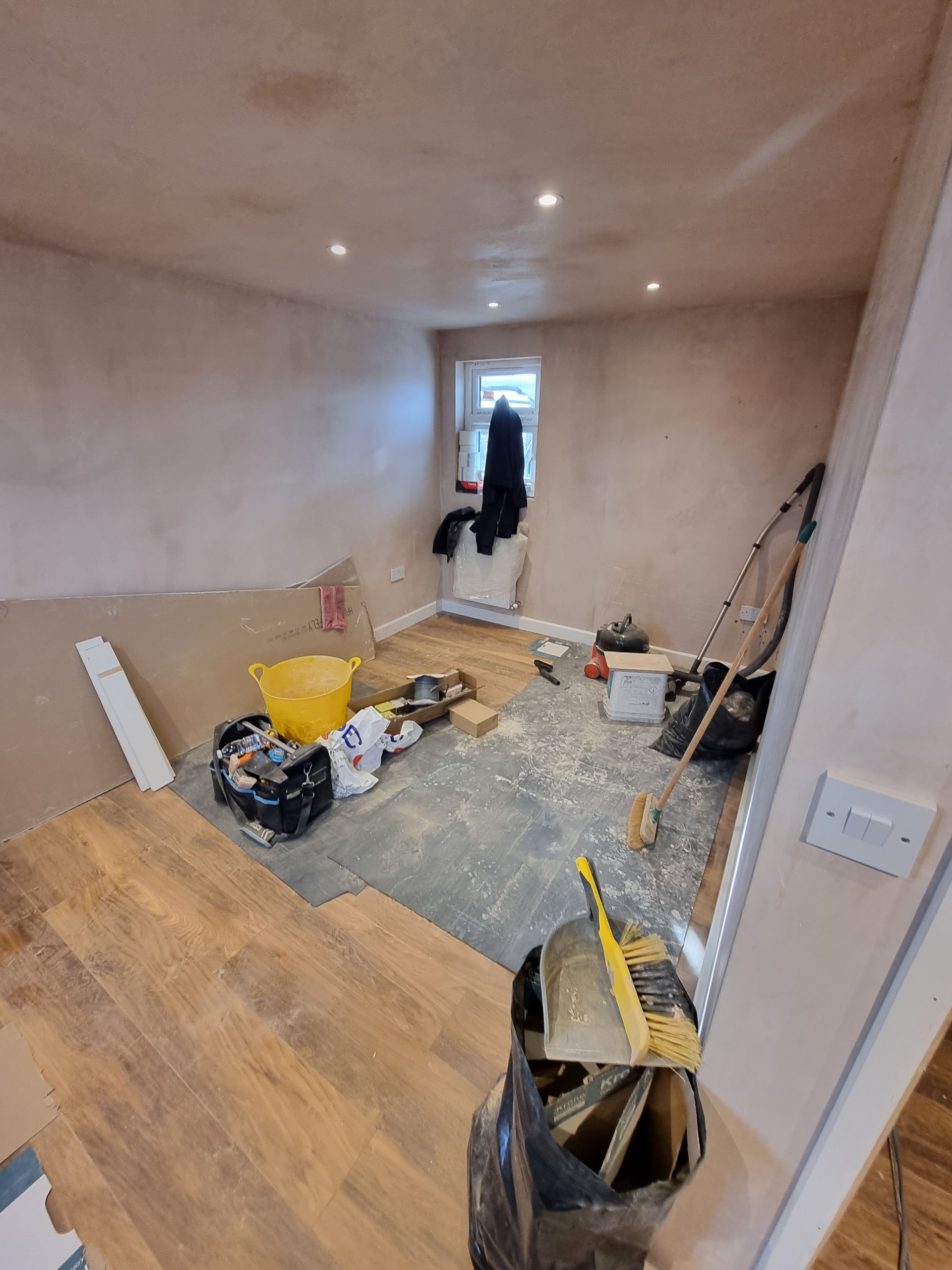 A room that is being remodeled with a lot of tools on the floor.