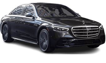 Black Mercedes-Benz sedan, parked, front view. Glossy paint, chrome grille, tinted windows, dark rims.