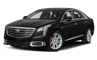 Black Cadillac XTS sedan, front view, parked, shiny exterior.