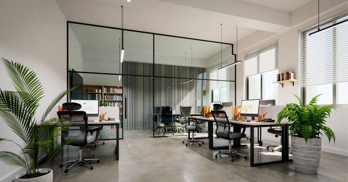 A modern office space with a glassed-in private office and an open layout with multiple desks and co