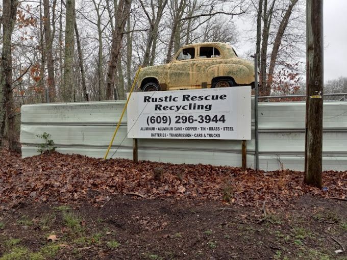 A sign that says rustic rescue recycling on it