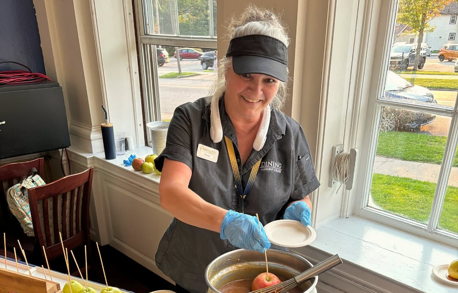 A man in a chef 's hat is posing for a picture with two other chefs