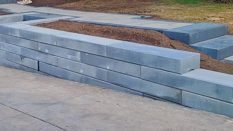 Completed natural stone, interlock, and wooden wall project