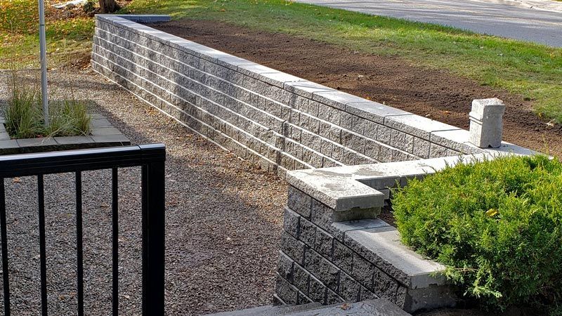 Completed natural stone, interlock, and wooden wall project