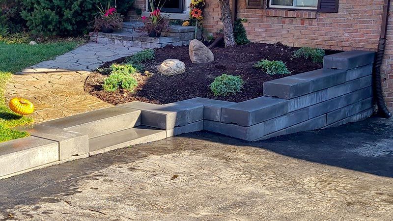 Completed natural stone, interlock, and wooden wall project