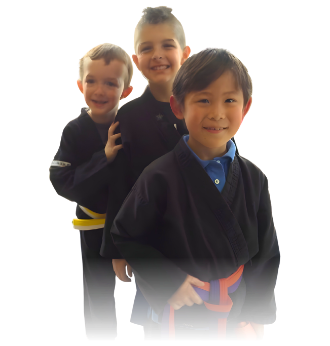 Man pointing, smiling, wearing black hoodie; arm tattoo visible.