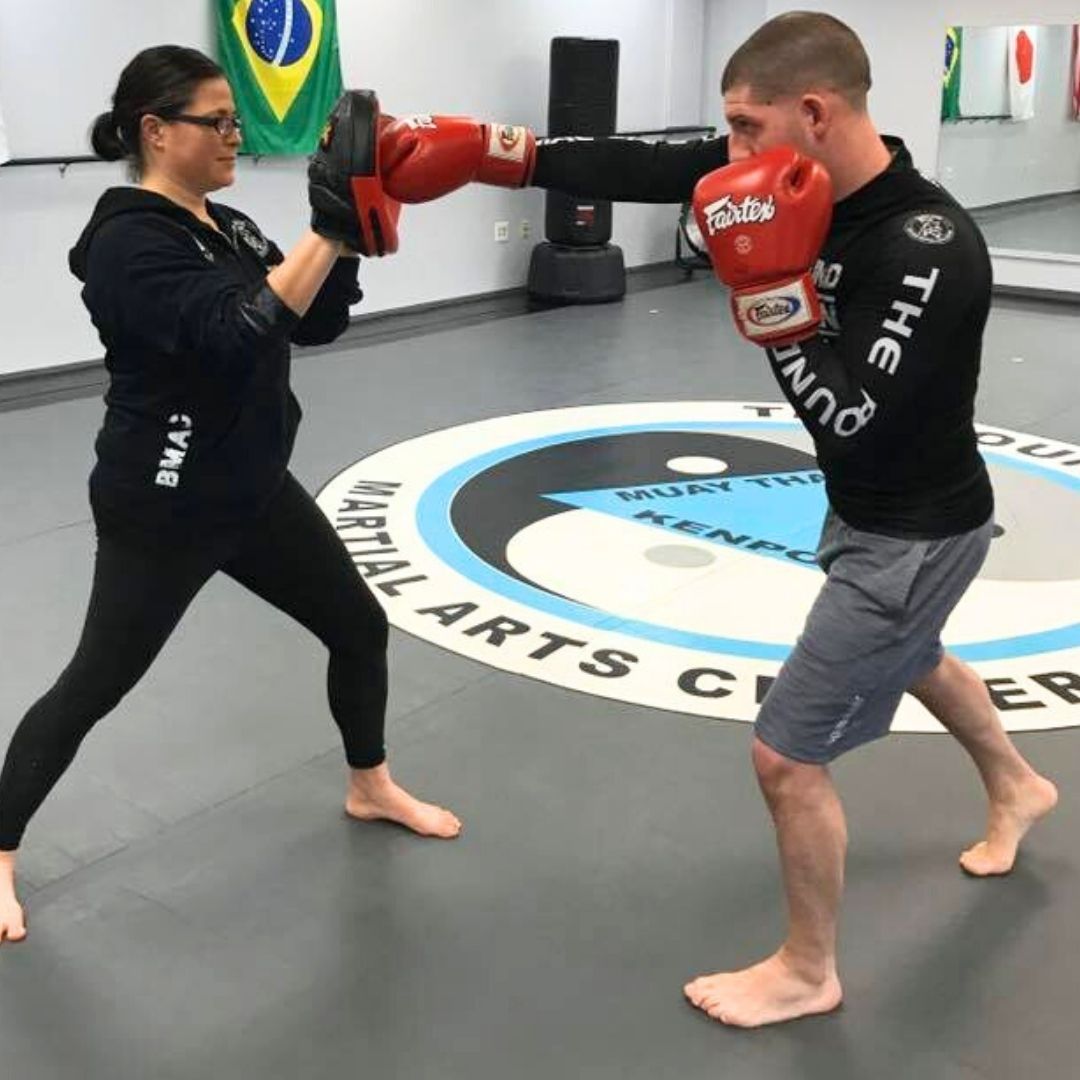 Four men in athletic gear, posing for a photo in a gym.