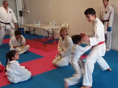 A group of people are practicing martial arts in a gym