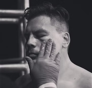 A man is being examined by a doctor in a black and white photo.