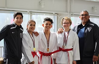A group of young people are posing for a picture while wearing medals.