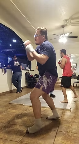 A group of men are practicing martial arts in a room.