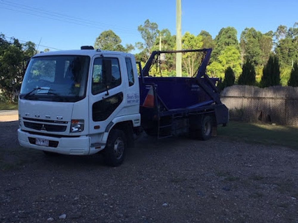 A Truck Is Parked On The Road With A Dumpster On The Back — Bears Bins Skip Hire In Meridan Plains,QLD