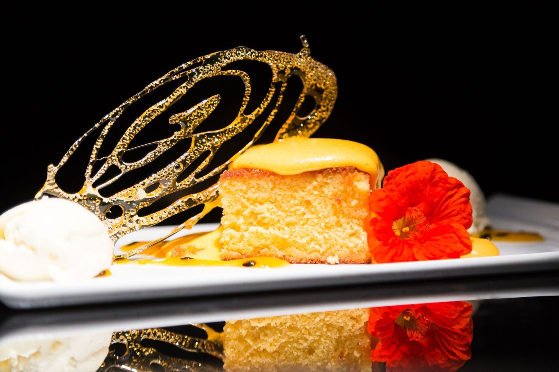 A white plate topped with a piece of cake and ice cream.