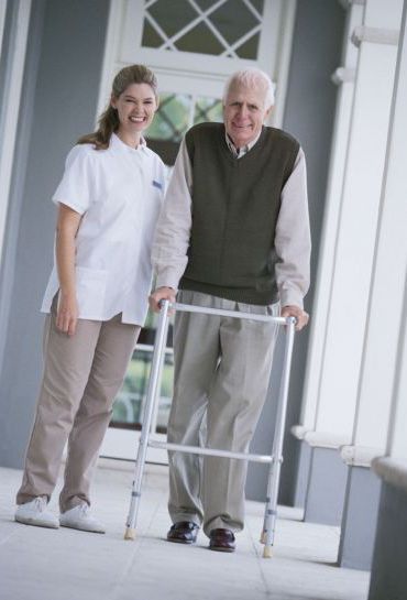 Woman assisting man with home care services in Milford, OH