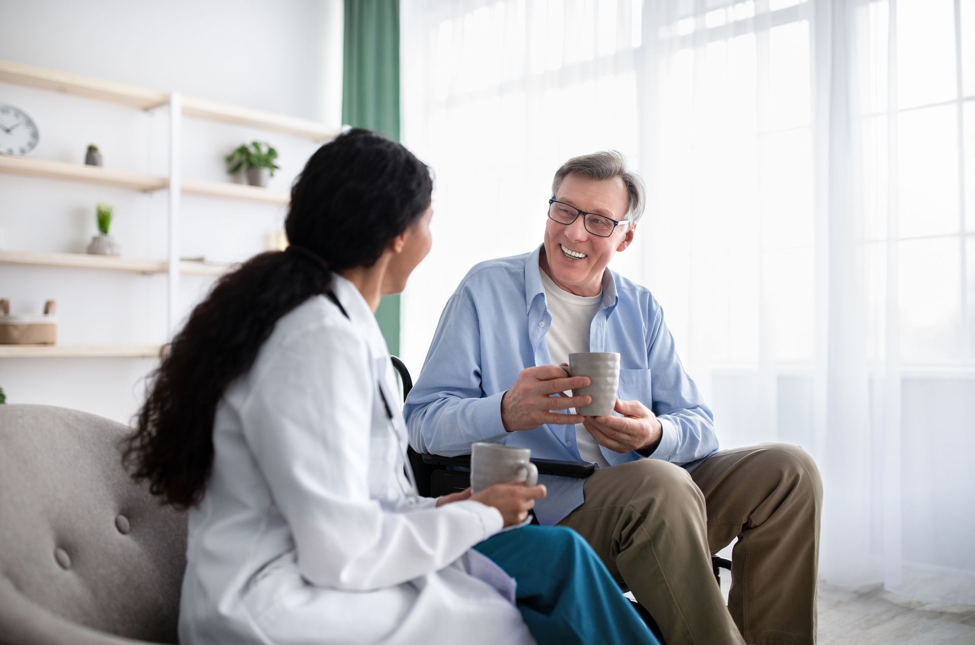 A doctor consulting a patient in a chair, showcasing personalized home health services at home. A doctor consulting a patient in a chair, showcasing personalized home health services at home.