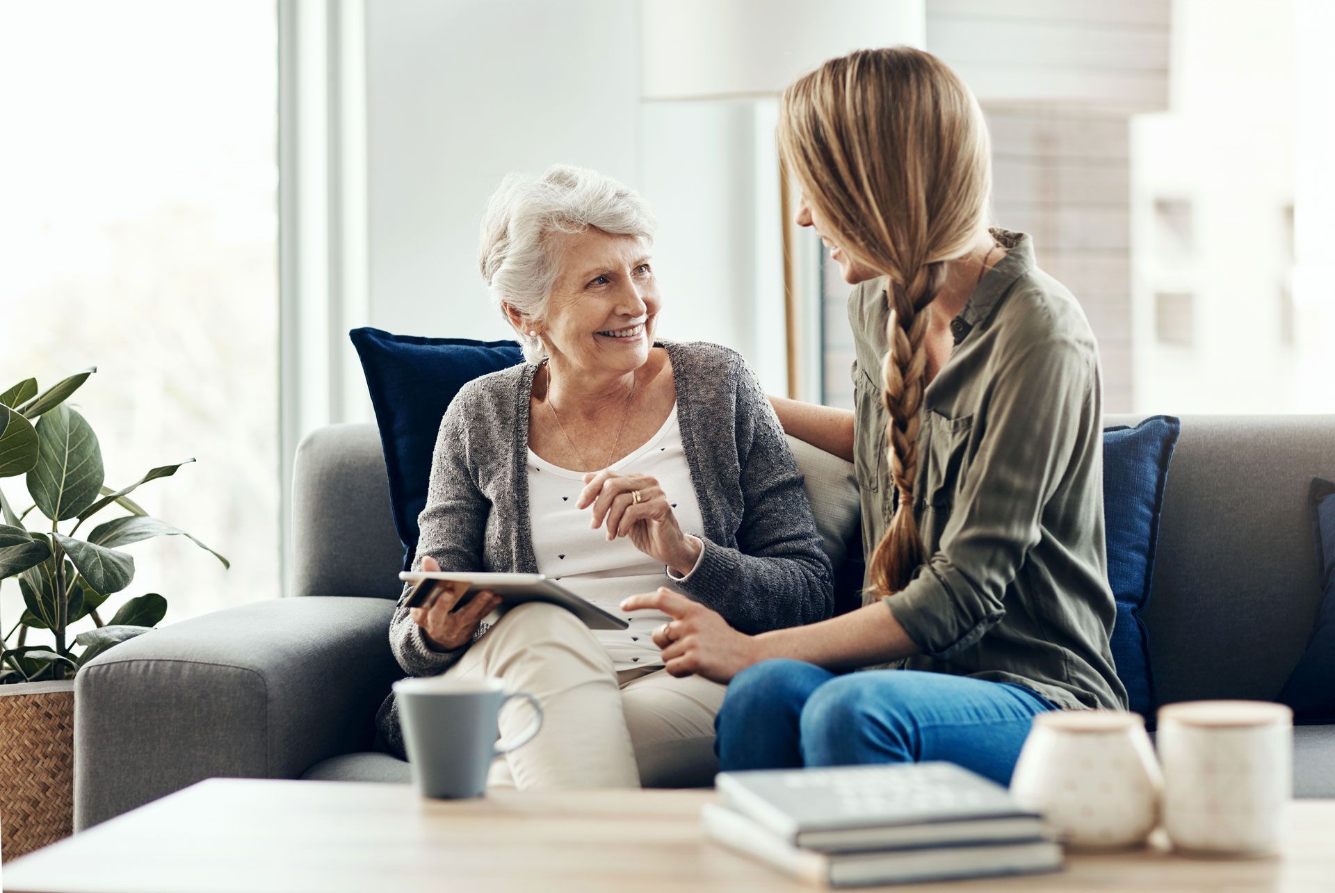 A woman is talking with a senior woman.