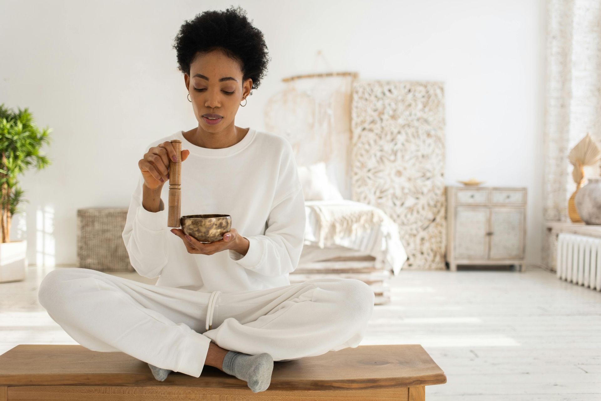 A pregnant woman is taking a pill and drinking a glass of water.