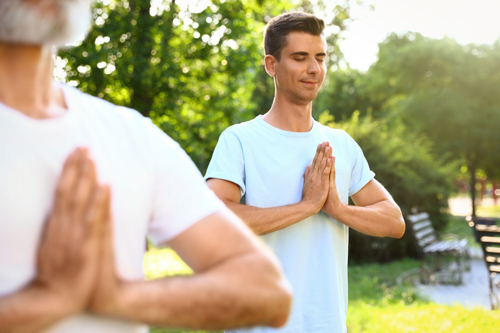  The man is practicing yoga in a park, to improve his overall heath and sperm quality