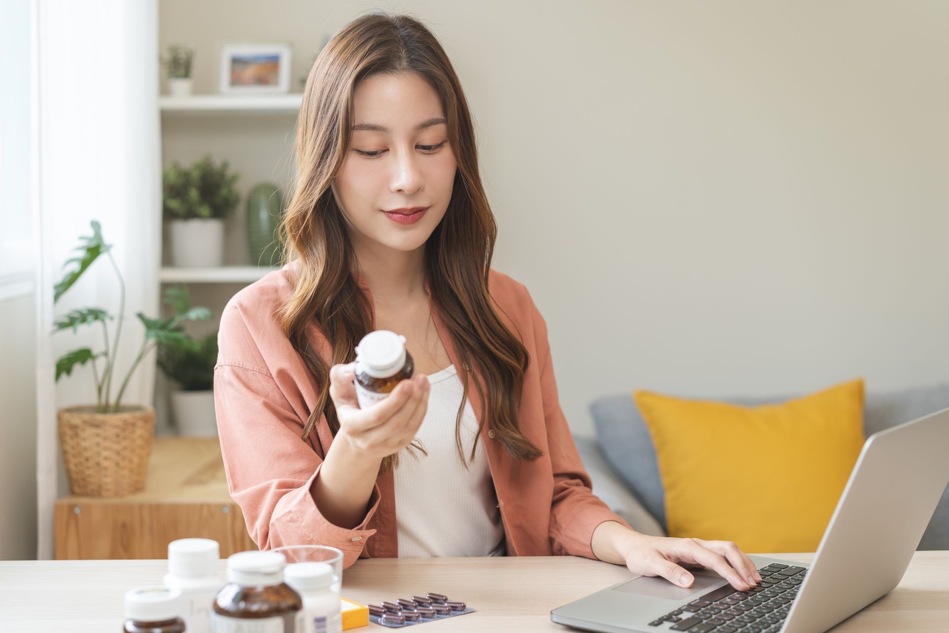 woman holding supplements doing research supplements for fertility