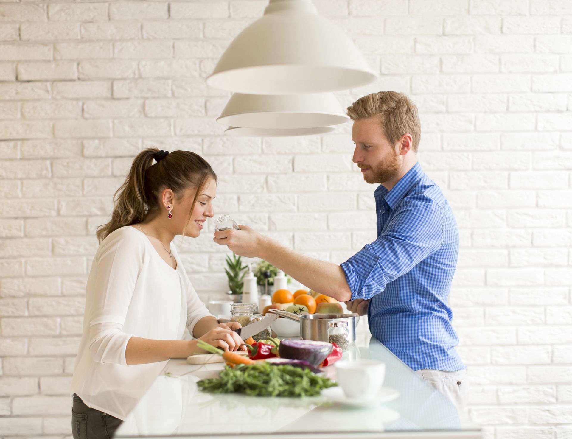 a young couple are cooking together, they are cooking with foods that are high in L-Arginine 